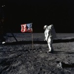 Man on the moon - U.S. Astronaut Edwin E. Aldrin, Jr., lunar module pilot of the first lunar landing mission, poses for a photograph beside the deployed United States flag during Apollo 11.