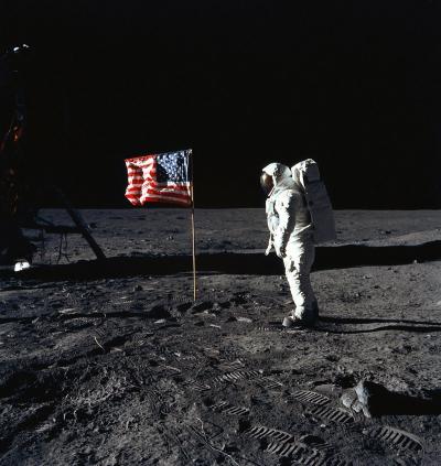 Man on the moon - U.S. Astronaut Edwin E. Aldrin, Jr., lunar module pilot of the first lunar landing mission, poses for a photograph beside the deployed United States flag during Apollo 11.